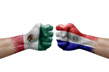 Two hands punch to each others on white background. Country flags painted fists, conflict crisis concept between mexico and paraguay
