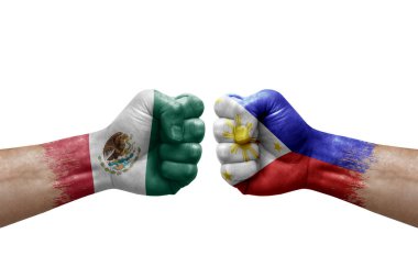 Two hands punch to each others on white background. Country flags painted fists, conflict crisis concept between mexico and philippines