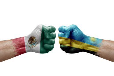 Two hands punch to each others on white background. Country flags painted fists, conflict crisis concept between mexico and rwanda