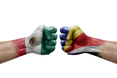 Two hands punch to each others on white background. Country flags painted fists, conflict crisis concept between mexico and seychelles