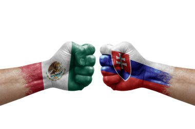 Two hands punch to each others on white background. Country flags painted fists, conflict crisis concept between mexico and slovakia