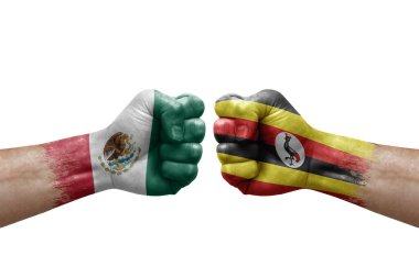 Two hands punch to each others on white background. Country flags painted fists, conflict crisis concept between mexico and uganda