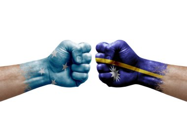 Two hands punch to each others on white background. Country flags painted fists, conflict crisis concept between micronesia and nauru