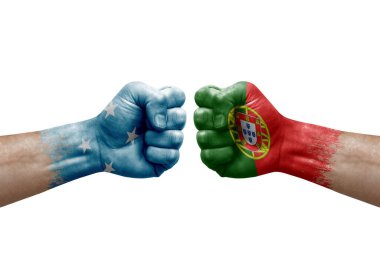 Two hands punch to each others on white background. Country flags painted fists, conflict crisis concept between micronesia and portugal