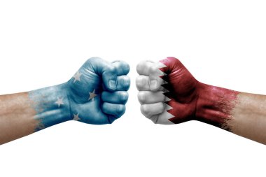 Two hands punch to each others on white background. Country flags painted fists, conflict crisis concept between micronesia and qatar