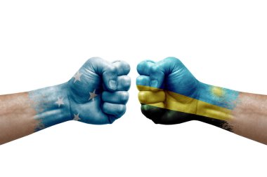 Two hands punch to each others on white background. Country flags painted fists, conflict crisis concept between micronesia and rwanda