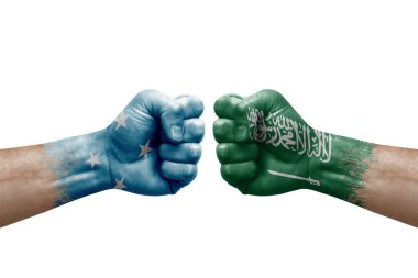 Two hands punch to each others on white background. Country flags painted fists, conflict crisis concept between micronesia and saudi arabia
