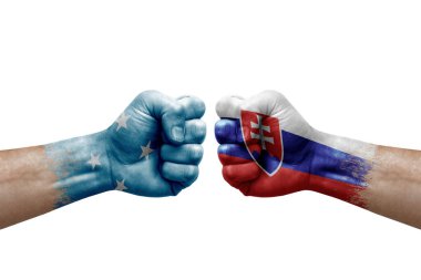 Two hands punch to each others on white background. Country flags painted fists, conflict crisis concept between micronesia and slovakia
