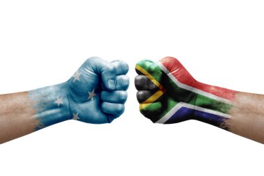 Two hands punch to each others on white background. Country flags painted fists, conflict crisis concept between micronesia and south africa