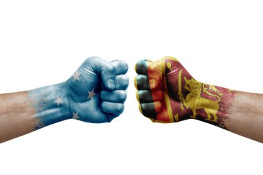 Two hands punch to each others on white background. Country flags painted fists, conflict crisis concept between micronesia and sri lanka