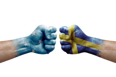 Two hands punch to each others on white background. Country flags painted fists, conflict crisis concept between micronesia and sweden