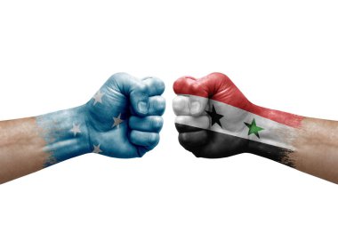 Two hands punch to each others on white background. Country flags painted fists, conflict crisis concept between micronesia and syria