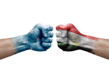 Two hands punch to each others on white background. Country flags painted fists, conflict crisis concept between micronesia and tajikistan