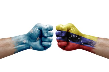 Two hands punch to each others on white background. Country flags painted fists, conflict crisis concept between micronesia and venezuela
