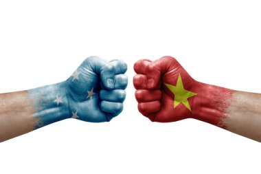 Two hands punch to each others on white background. Country flags painted fists, conflict crisis concept between micronesia and vietnam