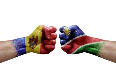 Two hands punch to each others on white background. Country flags painted fists, conflict crisis concept between moldova and namibia