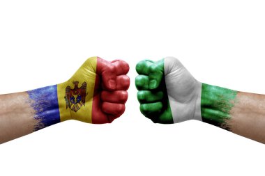 Two hands punch to each others on white background. Country flags painted fists, conflict crisis concept between moldova and nigeria