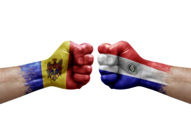 Two hands punch to each others on white background. Country flags painted fists, conflict crisis concept between moldova and paraguay