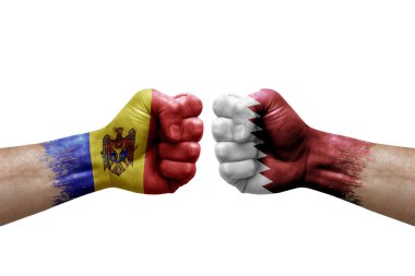 Two hands punch to each others on white background. Country flags painted fists, conflict crisis concept between moldova and qatar