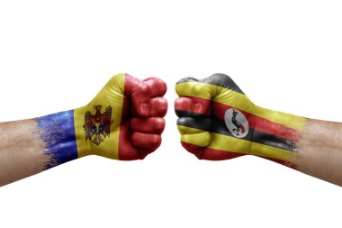 Two hands punch to each others on white background. Country flags painted fists, conflict crisis concept between moldova and uganda