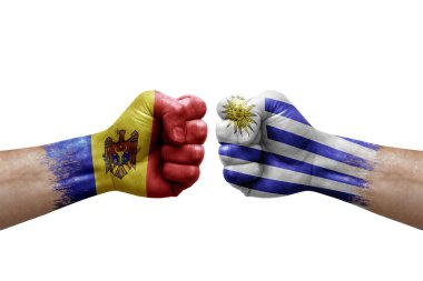 Two hands punch to each others on white background. Country flags painted fists, conflict crisis concept between moldova and uruguay