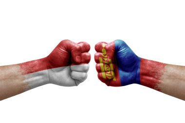 Two hands punch to each others on white background. Country flags painted fists, conflict crisis concept between monaco and mongolia