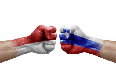 Two hands punch to each others on white background. Country flags painted fists, conflict crisis concept between monaco and slovenia