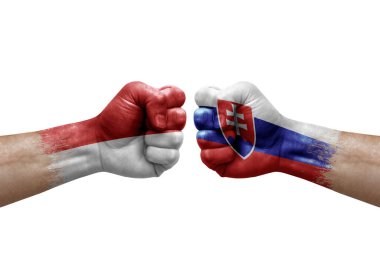 Two hands punch to each others on white background. Country flags painted fists, conflict crisis concept between monaco and slovakia