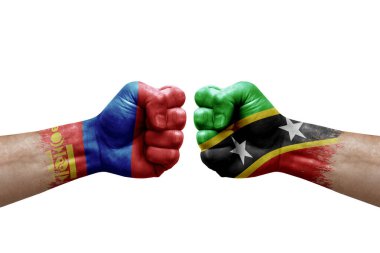 Two hands punch to each others on white background. Country flags painted fists, conflict crisis concept between mongolia and saint kitts and nevis
