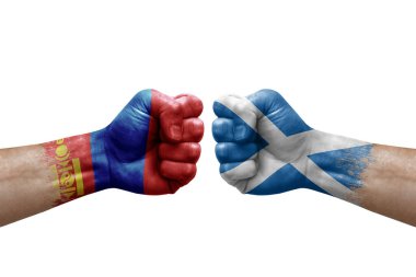 Two hands punch to each others on white background. Country flags painted fists, conflict crisis concept between mongolia and scotland
