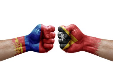 Two hands punch to each others on white background. Country flags painted fists, conflict crisis concept between mongolia and timor leste