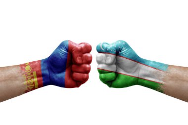 Two hands punch to each others on white background. Country flags painted fists, conflict crisis concept between mongolia and uzbekistan