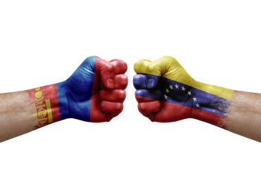 Two hands punch to each others on white background. Country flags painted fists, conflict crisis concept between mongolia and venezuela