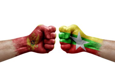 Two hands punch to each others on white background. Country flags painted fists, conflict crisis concept between montenegro and myanmar