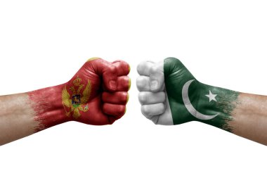 Two hands punch to each others on white background. Country flags painted fists, conflict crisis concept between montenegro and pakistan