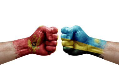 Two hands punch to each others on white background. Country flags painted fists, conflict crisis concept between montenegro and rwanda