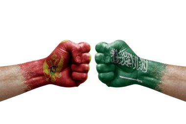 Two hands punch to each others on white background. Country flags painted fists, conflict crisis concept between montenegro and saudi arabia