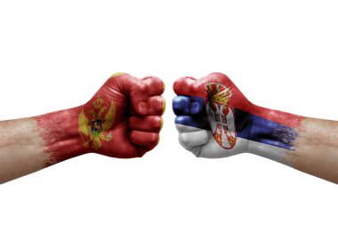 Two hands punch to each others on white background. Country flags painted fists, conflict crisis concept between montenegro and serbia