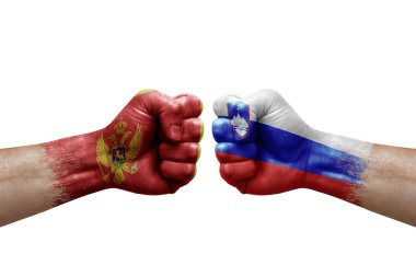 Two hands punch to each others on white background. Country flags painted fists, conflict crisis concept between montenegro and slovenia