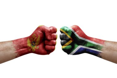 Two hands punch to each others on white background. Country flags painted fists, conflict crisis concept between montenegro and south africa