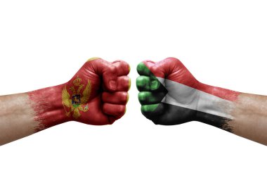 Two hands punch to each others on white background. Country flags painted fists, conflict crisis concept between montenegro and sudan