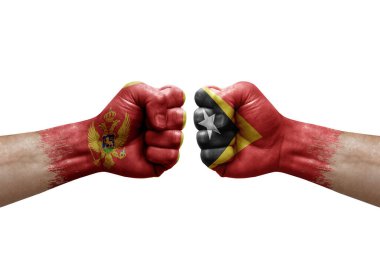 Two hands punch to each others on white background. Country flags painted fists, conflict crisis concept between montenegro and timor leste