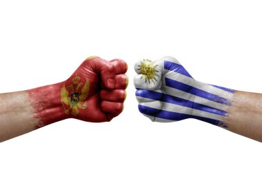 Two hands punch to each others on white background. Country flags painted fists, conflict crisis concept between montenegro and uruguay