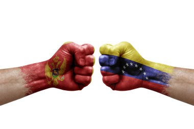 Two hands punch to each others on white background. Country flags painted fists, conflict crisis concept between montenegro and venezuela