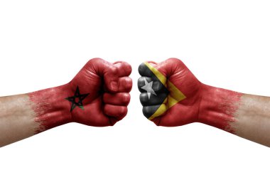Two hands punch to each others on white background. Country flags painted fists, conflict crisis concept between morocco and timor leste