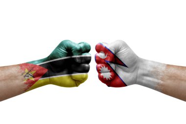 Two hands punch to each others on white background. Country flags painted fists, conflict crisis concept between mozambique and nepal