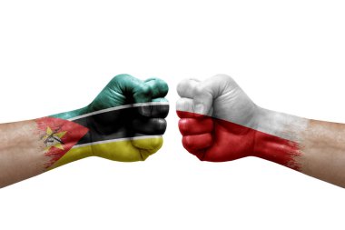 Two hands punch to each others on white background. Country flags painted fists, conflict crisis concept between mozambique and poland