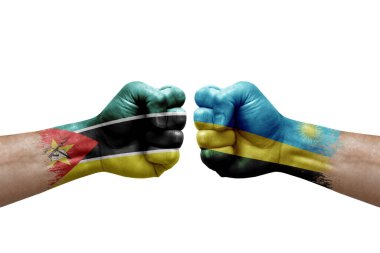 Two hands punch to each others on white background. Country flags painted fists, conflict crisis concept between mozambique and rwanda