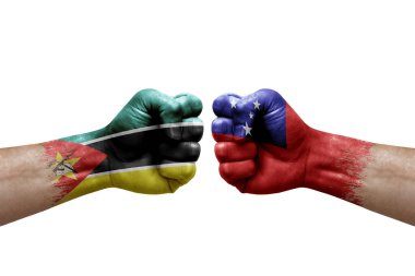 Two hands punch to each others on white background. Country flags painted fists, conflict crisis concept between mozambique and samoa