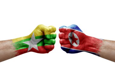 Two hands punch to each others on white background. Country flags painted fists, conflict crisis concept between myanmar and north korea